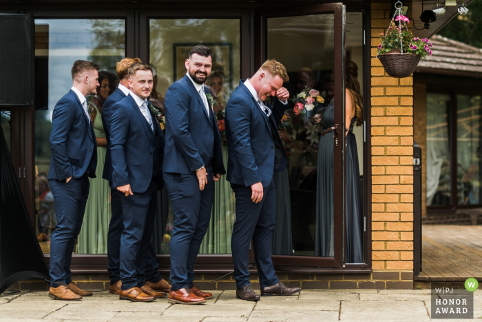 Photo by: <a href="https://www.wpja.com/contests/2018-v10-photography-competition/best-wedding-photographers/2246296">Paul Mockford - Rushden Northamptonshire</a> ushers and bridesmaids waiting to pair up at a Private house, Northamptonshire