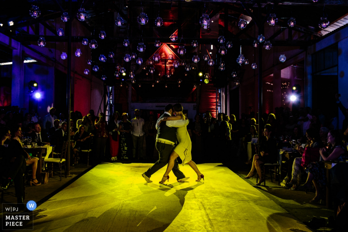 reception photography showing the bride and groom during their first dance under the lights. Oaxaca, Mexico wedding reception photo of the bride and groom during their first dance under the lights.