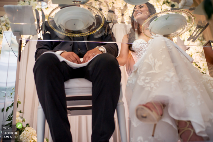 bride and groom at the head table Westin Hotel, Halifax, Nova Scotia - bride and groom at the head table as shot from below their glass table