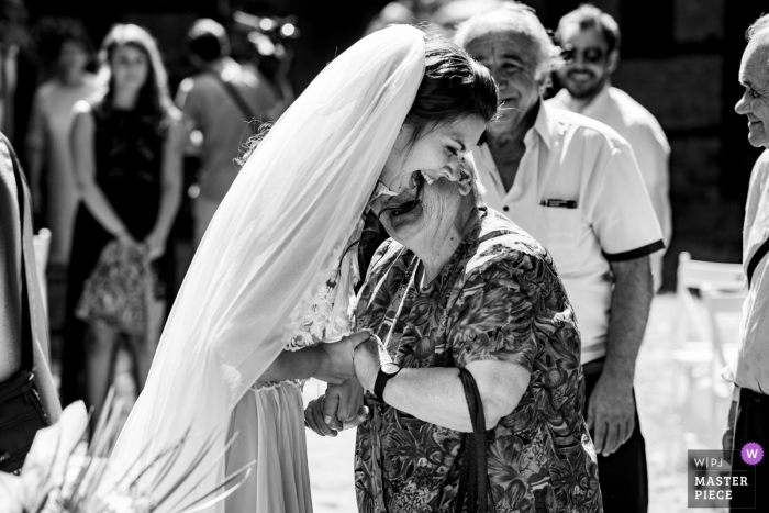 Photo by: <a href="https://www.wpja.com/contests/2018-v12/best-wedding-photographers/2275036">Hristina Handzhieva - Lovech </a> Lovech Wedding Photo of the bride greeting an elderly guest outdoors