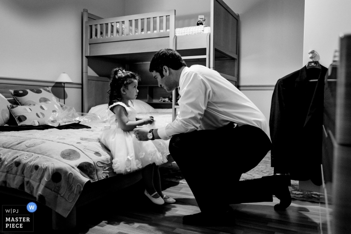 Beirut, Lebanon young flower girl is helped with her dress while getting ready Beirut, Lebanon Wedding Photojournalist | a young flower girl is helped with her dress while getting ready