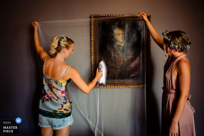 Photo by: <a href="https://www.wpja.com/contests/2018-v13/best-wedding-photographers/2287046">Steven Herrschaft - Lützelbach Hessen</a> Hesse Wedding Photojournalist | the bride steams her veil while getting ready in Germany