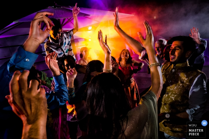 Photo by: <a href="https://www.wpja.com/contests/2018-v13/best-wedding-photographers/2287291">Khoi Le - Ho Chi Minh City </a> Croatia Wedding Photojournalist | very colorful Image of guests dancing at the wedding reception
