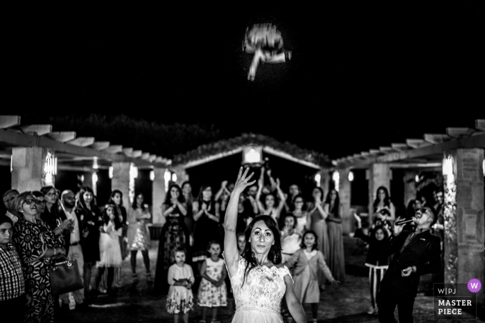 Photo by: <a href="https://www.wpja.com/contests/2018-v13/best-wedding-photographers/2287916">Matteo Lomonte - Gioia del Colle Bari</a> wedding photography in puglia | bride tossing bouquet of flowers at night