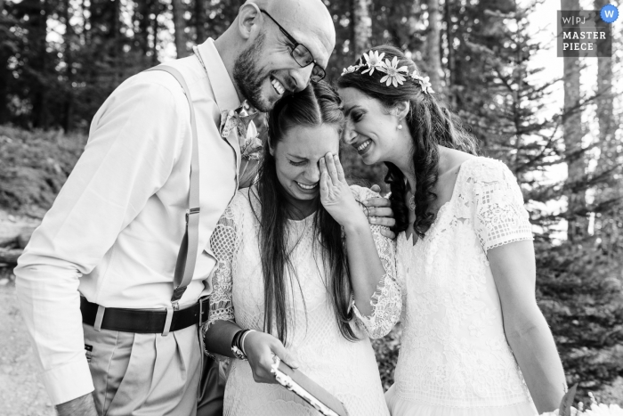 Photo by: <a href="https://www.wpja.com/contests/2018-v13/best-wedding-photographers/2288251">David Clumpner - Missoula Montana</a> Glacier National Park Wedding Photojournalist | the bride and groom console an emotional woman during their outdoor ceremony