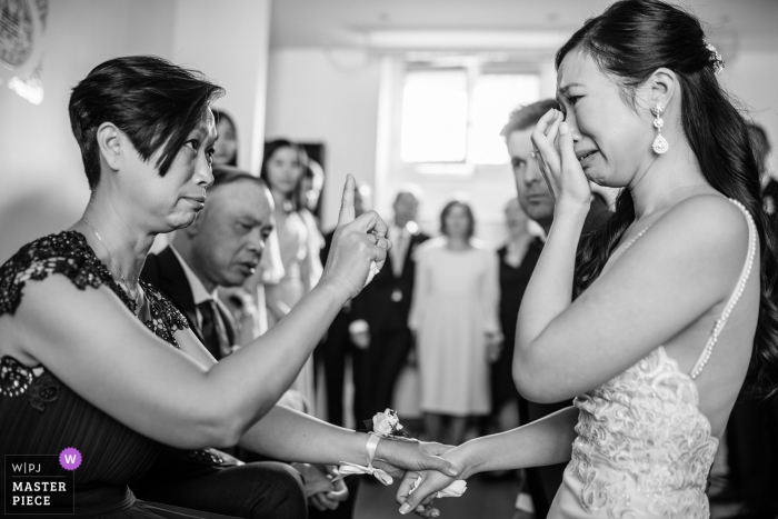 Photo by: <a href="https://www.wpja.com/contests/2018-v13/best-wedding-photographers/2288426">Jacques Mateos - Paris </a> Paris Wedding Photojournalist | the bride and her mother share an emotional moment together at the wedding