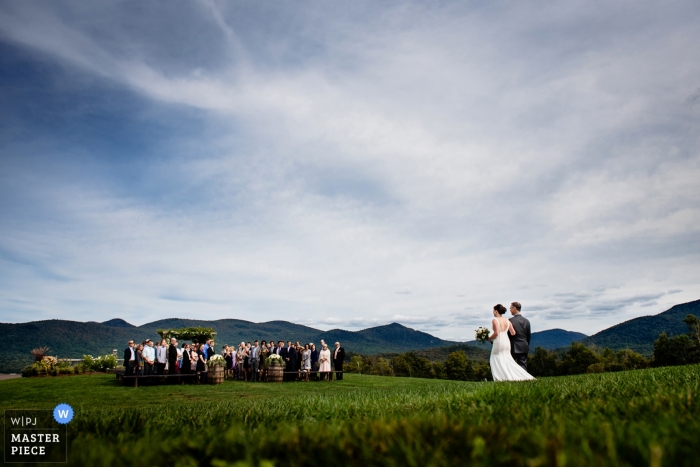 Photo by: <a href="https://www.wpja.com/contests/2018-v13/best-wedding-photographers/2289696">Megan Hannah - Lincoln Vermont</a> The bride and her father make the long walk through the field to the outdoor ceremony in Chittenden, Vermont