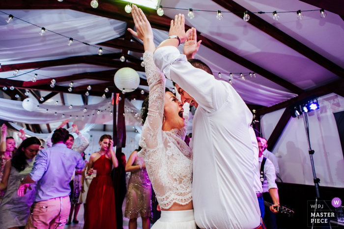 Harghita Wedding Photojournalist | wedding reception photo of the bride and groom dancing in Romania