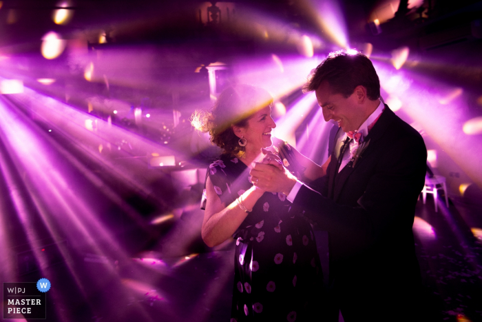 Photo by: <a href="https://www.wpja.com/contests/2018-v14/best-wedding-photographers/2295621">Sylvain Bouzat - Lyon </a> Provence Wedding Photojournalist | purple DJ lights on the dance floor for this pair
