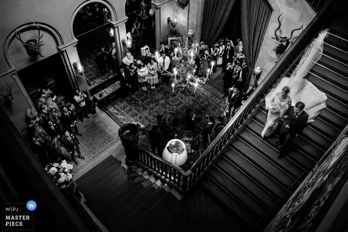 Photo by: <a href="https://www.wpja.com/contests/2018-v15/best-wedding-photographers/2305151">Aaron Storry - Kettering Northamptonshire</a> Eastnor Castle, United Kingdom wedding photograph of bride heading down the stairs at the reception