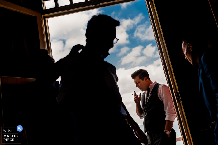 Photo by: <a href="https://www.wpja.com/contests/2018-v15/best-wedding-photographers/2310536">Vlad Lodoaba - București</a> Istanbul groom and groomsmen get dressed and smoke cigarettes while getting ready
