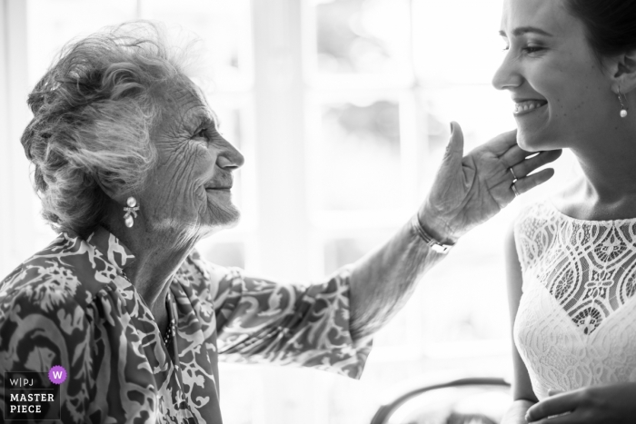 France Royan grandmother touches the brides cheek at the wedding