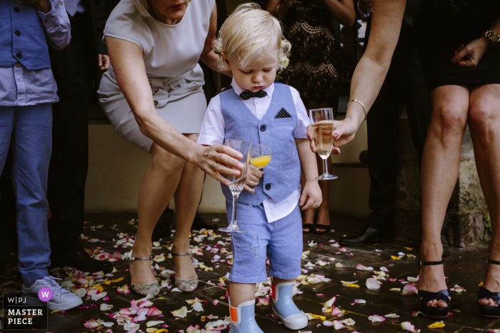 Photo by: <a href="https://www.wpja.com/contests/2018-v15/best-wedding-photographers/2312411">Rosa Engel - Aachen Nordrhein-Westfalen</a> Documentary wedding photograph at Aachen wedding reception with guests clanking glasses with a young boy