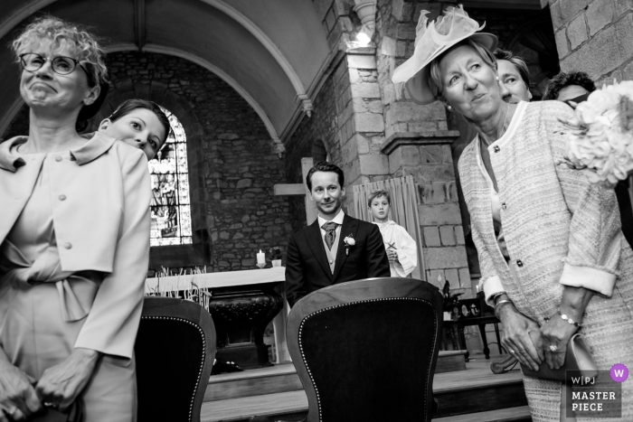 Photo by: <a href="https://www.wpja.com/contests/2018-v15/best-wedding-photographers/2315221">Sybil Rondeau - Nantes </a> Wedding picture of the groom waiting for the bride to enter the church, by Nantes photographer