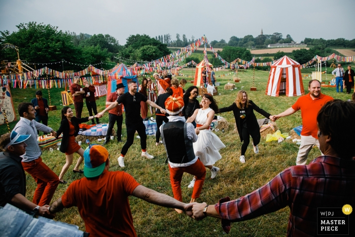 Photo by: <a href="https://www.wpja.com/contests/2018-v15/best-wedding-photographers/2318446">Artem Pitkevich - Saint-Petersburg </a> England wedding shoot with a couple celebrating and dancing at their festival carnival wedding day reception