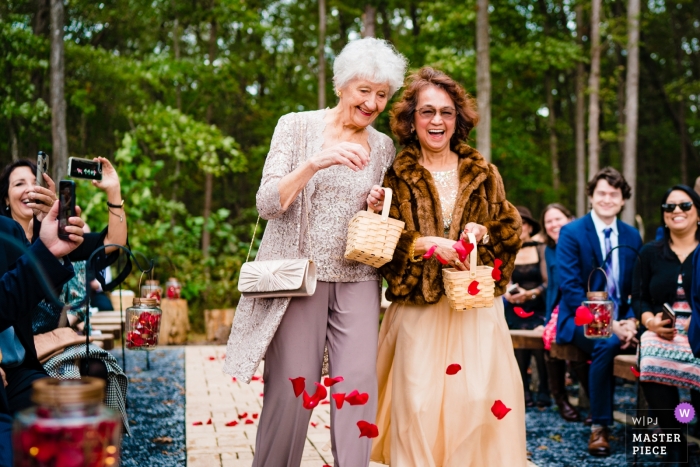 Photo by: <a href="https://www.wpja.com/contests/2018-v15/best-wedding-photographers/2318746">Johnny Shryock - Arlington Virginia</a> Shenandoah Woods, Luray wedding photo of the flower girl moms tossing petals before the outdoor ceremony.