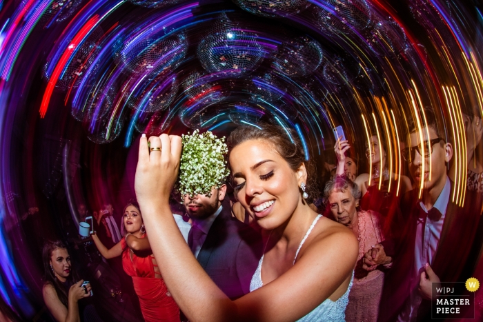 Photo by: <a href="https://www.wpja.com/contests/2018-v15/best-wedding-photographers/2318821">Wander Menezes - Belo Horizonte Minas Gerais</a> Minas Gerais wedding photograph of woman dancing to a slow shutter speed
