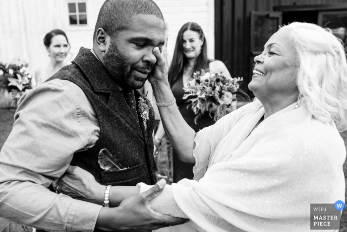 Photo by: <a href="https://www.wpja.com/contests/2018-v18/best-wedding-photographers/2345671">David Clumpner - Missoula Montana</a> Wedding photojournalism in Belgrade, Montana - Mom wipes away a tear after ceremony