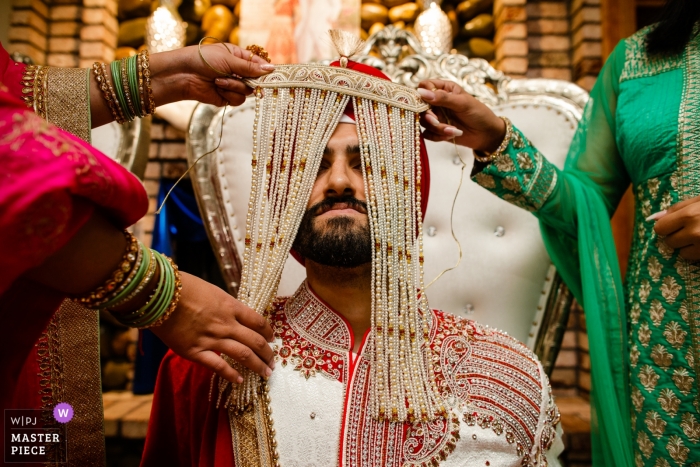Photo by: <a href="https://www.wpja.com/contests/2018-v18/best-wedding-photographers/2348941">Raymond Nguyen - Sacramento California</a> Sacramento wedding photograph of a girl with traditional Indian headwear during the ceremony