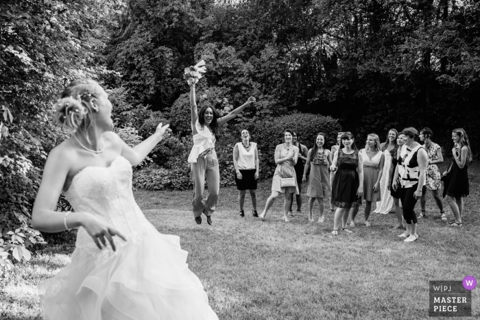 Photo by: <a href="https://www.wpja.com/contests/2018-v18/best-wedding-photographers/2351261">Charlène Aubert - Novalaise </a> Auvergne-Rhône-Alpes wedding photograph of bride throwing bouquet - happy guest catches it