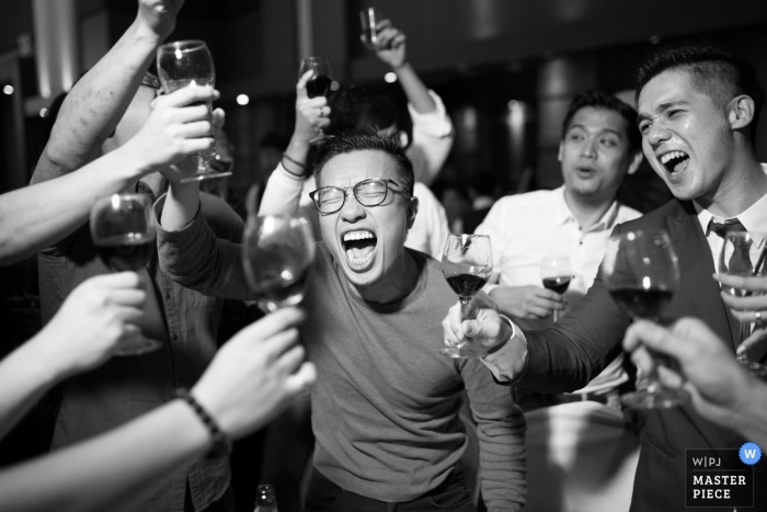 Photo by: <a href="https://www.wpja.com/contests/2018-v18/best-wedding-photographers/2352906">Chin Whei Tay - Malacca</a> Malacca wedding photograph of the groom and his friends toasting with wine glasses in their hands