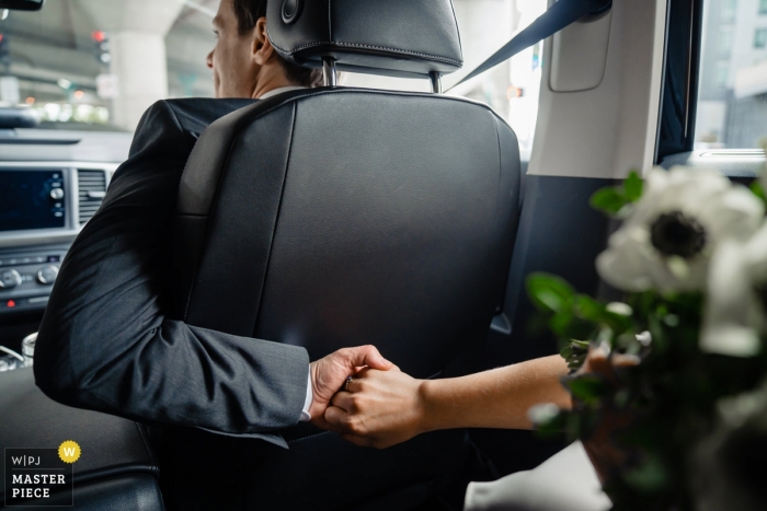 Photo by: <a href="https://www.wpja.com/contests/2018-v18/best-wedding-photographers/2361916">Nicole Chan - Quincy Massachusetts</a> Boston wedding photojournalism image of a couple during their Uber drive