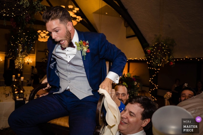 Photo by: <a href="https://www.wpja.com/contests/2018-v18/best-wedding-photographers/2361931">Nicole Chan - Quincy Massachusetts</a> Boston documentary wedding photo - bar harbor club groom lifted in chair