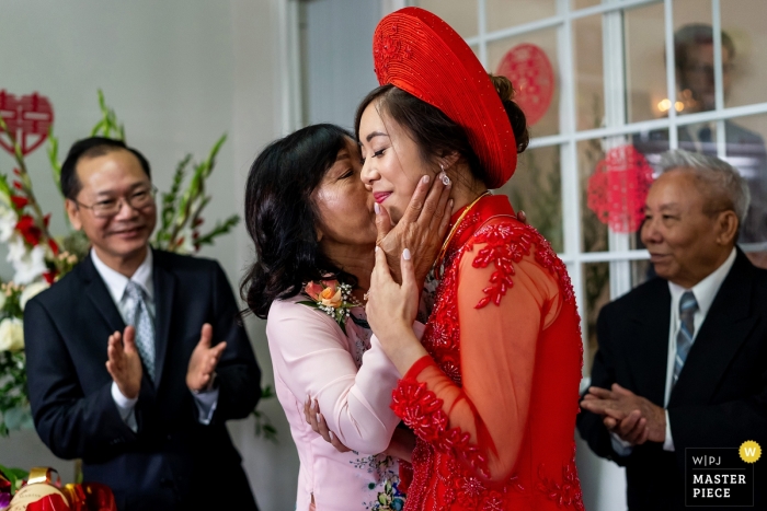 Photo by: <a href="https://www.wpja.com/contests/2018-v18/best-wedding-photographers/2361971">Shaun Baker - San Diego California</a> Anaheim, California wedding photo of mom kissing bride | CA wedding photography