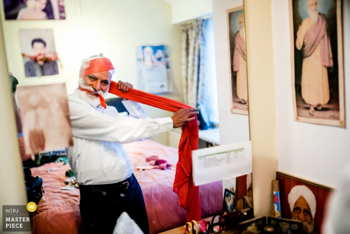 Photo by: <a href="https://www.wpja.com/contests/2018-v18/best-wedding-photographers/2363381">Paul Rogers - Hitchin Hertfordshire</a> Micklefield Hall, UK documentary wedding photo of man getting ready