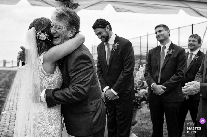 Photo by: <a href="https://www.wpja.com/contests/2018-v18/best-wedding-photographers/2364416">Tara Theilen - Carson City Nevada</a> Nantucket, Massachusetts wedding photo | wedding photograph of bride getting hug during ceremony