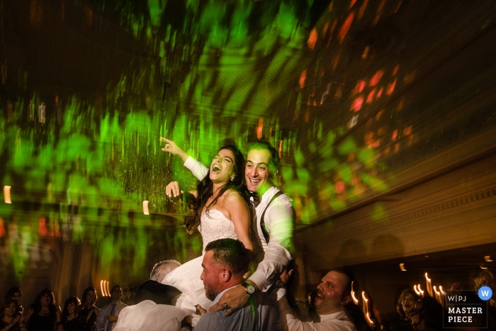 Photo by: <a href="https://www.wpja.com/contests/2018-v18/best-wedding-photographers/2364831">Denis Gostev - Richmond Hill New York</a> Queens wedding shoot with a couple high above the guests on the dance floor at the reception venue
