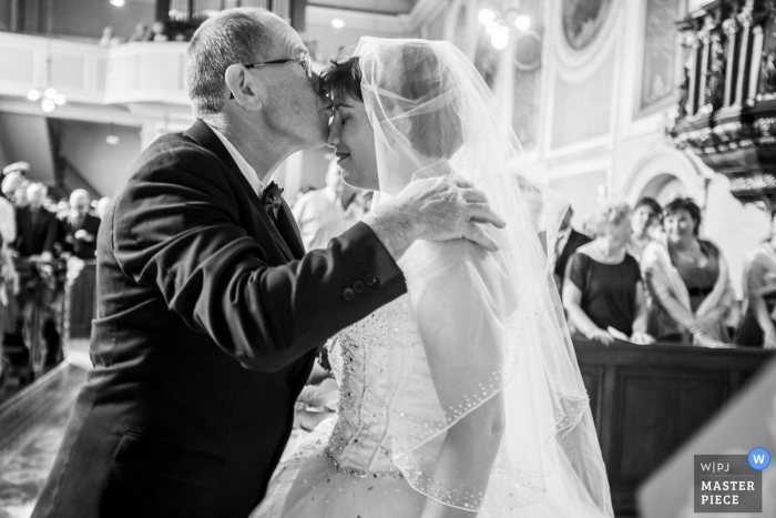 Photo by: <a href="https://www.wpja.com/contests/2018-v19/best-wedding-photographers/2367041">Nicolas Bernard - Ammerschwihr </a> Bouxwiller Documentary wedding photograph of bride getting kissed during ceremony