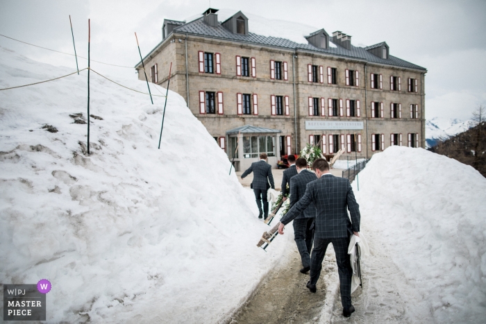 Photo by: <a href="https://www.wpja.com/contests/2018-v19/best-wedding-photographers/2367991">Sylvain Bouzat - Lyon </a> French wedding photograph of groomsmen arriving in the snow in Chamonix