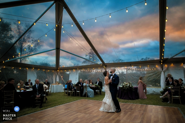 Photo by: <a href="https://www.wpja.com/contests/2018-v19/best-wedding-photographers/2372386">Katherine Birkbeck - Knoxville Tennessee</a> Knoxville wedding shoot with a couple during first dance under clear tented Tennessee reception