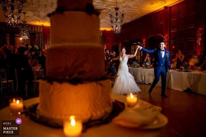 Photo by: <a href="https://www.wpja.com/contests/2018-v19/best-wedding-photographers/2373526">Victoria Sprung - Chicago Illinois</a> Chicago documentary wedding photo of bride and groom lit during first dance with their cake at Illinois reception
