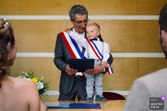Photo by: <a href="https://www.wpja.com/contests/2018-v19/best-wedding-photographers/2376911">Marine Poron - Paris </a> Wedding photo from Grenoble ceremony with a couple and a small boy as officiant