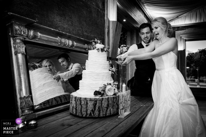 Photo by: <a href="https://www.wpja.com/contests/2018-v19/best-wedding-photographers/2378141">Emil Boczek - Wolverhampton West Midlands</a> Wedding shoot with Gloucestershire, UK couple cutting their cake with mirror reflection