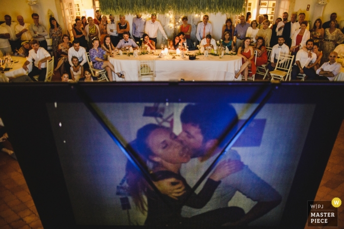 Photo by: <a href="https://www.wpja.com/contests/2019-v01/best-wedding-photographers/2430516">Daniel Monteiro - Porto </a> Mafra, Portugal wedding reception with a projected slideshow of the bride and groom