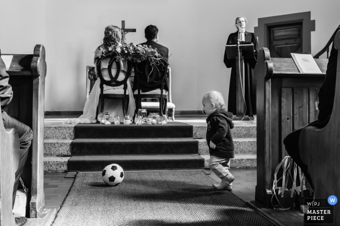 Foto: <a href="https://www.wpja.com/contests/2019-v01/best-wedding-photographers/2432206"> David Anton - Oberkirch Baden-Württemberg </a> Hochzeit in Schramberg-Tennenbronn - ein Kind spielt in der Kirche Fußball