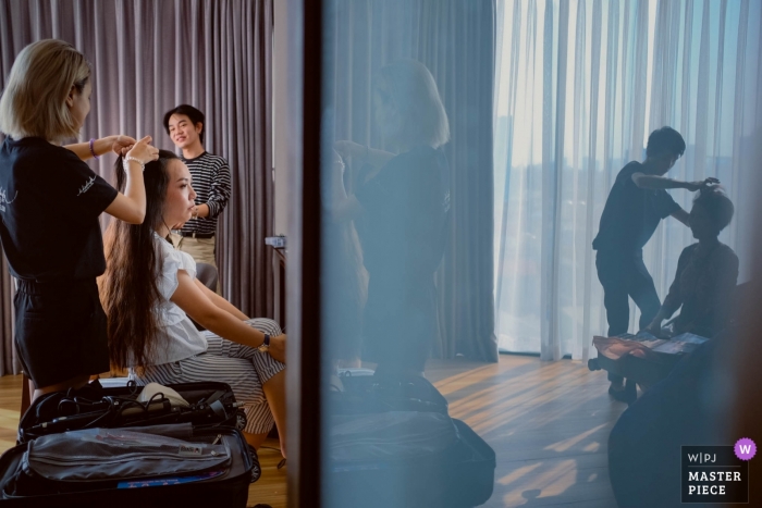 Photo by: <a href="https://www.wpja.com/contests/2019-v01/best-wedding-photographers/2433216">An Le - Ho Chi Minh </a> Ho Chi Minh City actual wedding day - Everybody is getting ready in this photograph with reflections
