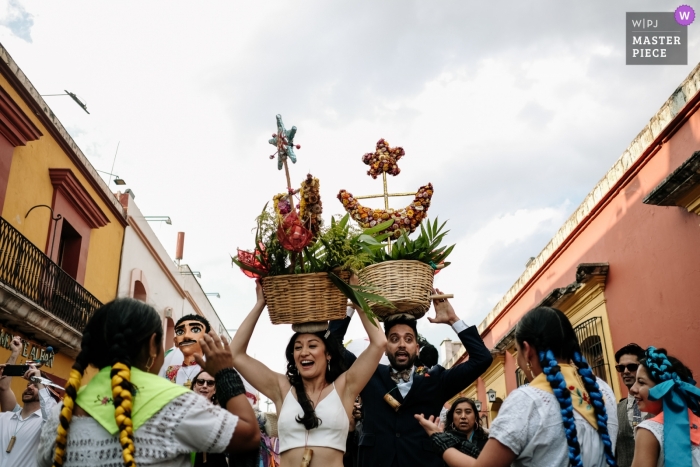 Photo by: <a href="https://www.wpja.com/contests/2019-v01/best-wedding-photographers/2433391">Nikhol Esteras - Oaxaca de Juárez Oaxaca</a> Oaxaca City, Oaxaca, Mexico - Wedding Calenda, Brian Groom walking the streets with baskets on their heads
