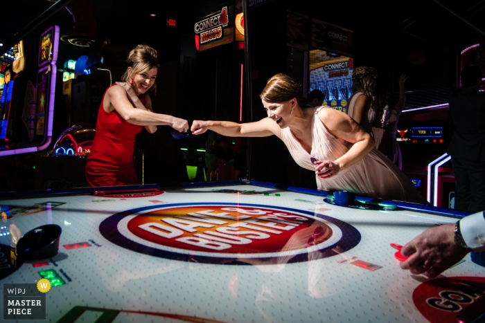 Photo by: <a href="https://www.wpja.com/contests/2019-v01/best-wedding-photographers/2435536">Janine Cooper - Omaha Nebraska</a> Elkhorn, NE Wedding Party knucks after scoring a goal during an air hockey match