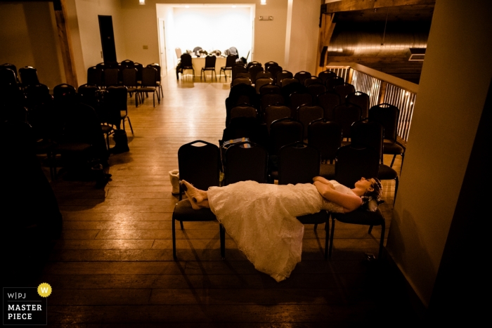 image of The bride, who woke up the morning of her wedding sick, takes a break during the reception at Mountain Top Inn, Chittenden, VT The bride, who woke up the morning of her wedding sick, takes a break during the reception - Mountain Top Inn, Chittenden, VT
