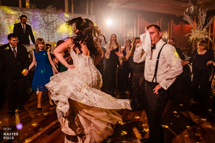 Photo by: <a href="https://www.wpja.com/contests/2019-v01/best-wedding-photographers/2438551">Denis Gostev - Richmond Hill New York</a> Baku Palace Restaurant wedding receptions - the groom is Taking a break on the dance floor as his bride continues to dance