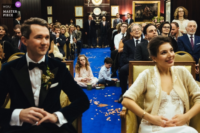 Kensihngton Town Hall wedding ceremony photography - Kids and confetti on the blue carpet runner