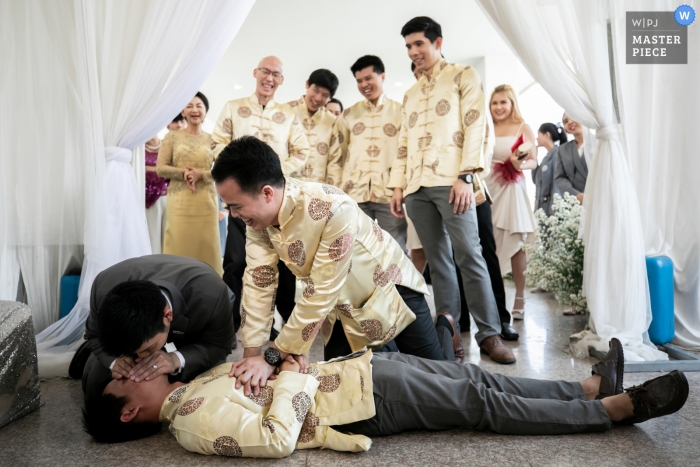 Photo by: <a href="https://www.wpja.com/contests/2019-v02/best-wedding-photographers/2444276">Chaiyasith Junjuerdee - Fulham London</a> Roi Et, Thailand wedding photographer | Restore respiration demonstration on the wedding day CPR