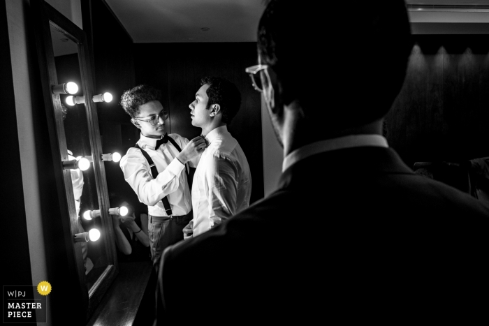 Hotel wedding photography of the Groom getting ready in a Black and white photograph with groomsmen The Palace Hotel Dubai wedding photography | Groom getting ready - Black and white photograph with groomsmen