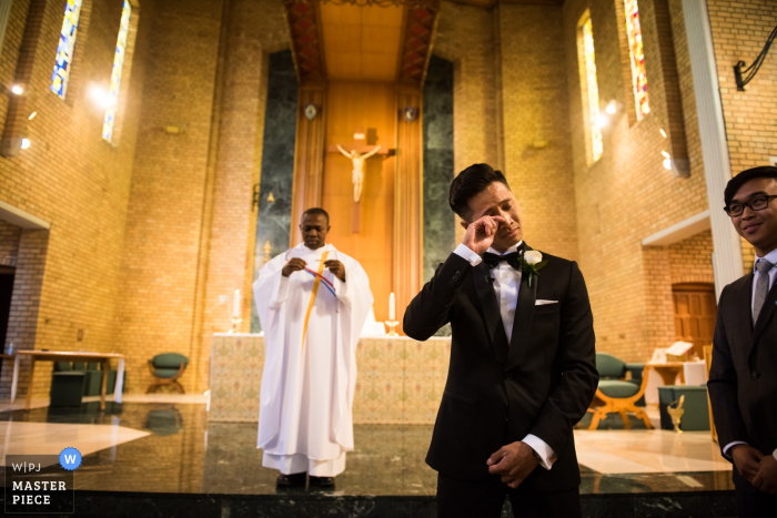 Victoria-AU Church wedding photography - the groom fights back tears - Bride coming 