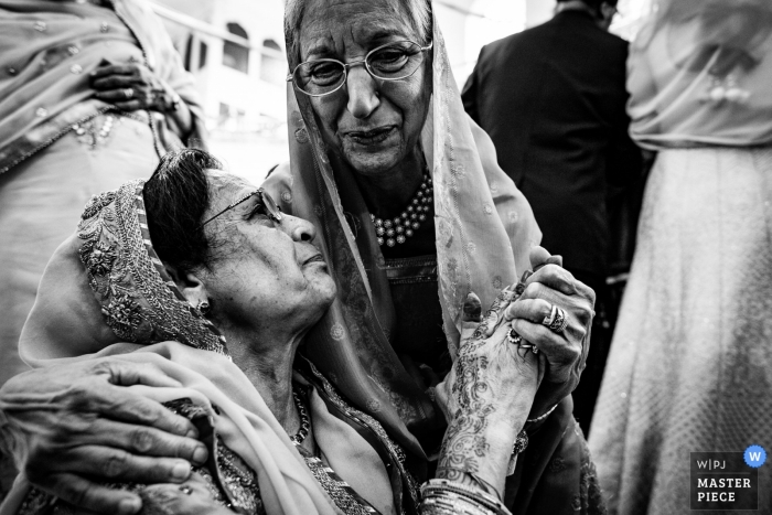 Birmingham, UK wedding photographers | Mother of the groom hugging in a black-and-white photograph 