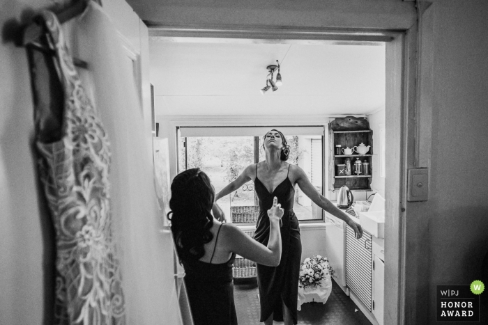 Cupitts Winery Wedding Photo - Bridesmaids spray each other with insect repellant to ward off the flies and mozzies prior to the Wedding Ceremony 